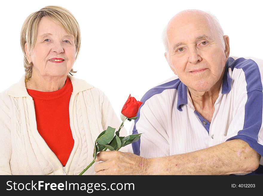 Happy seniors with Valentines rose isolated on white