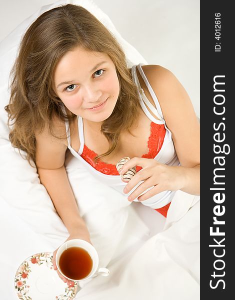 Young Girl Drinking Tea In Bed