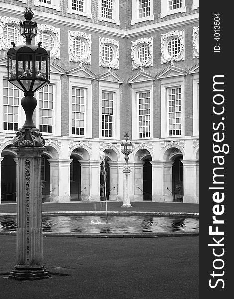 Courtyard with lamp posts and fountain at Hampton Court Palace, London. Courtyard with lamp posts and fountain at Hampton Court Palace, London