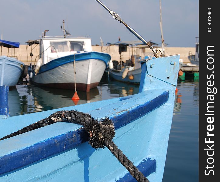 Part of the old blue boat against the background of port. Part of the old blue boat against the background of port