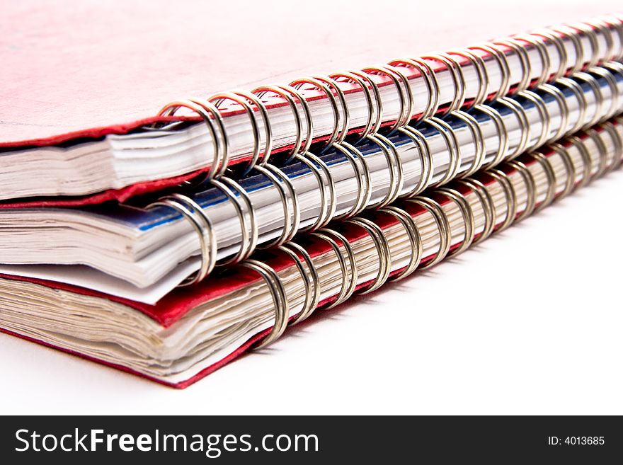 A stack of three lesson plan books with metal coil binding.