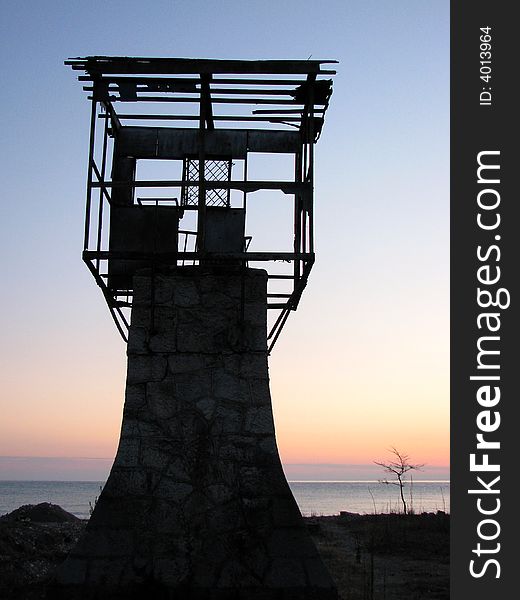 Old tower on the sunset beach. Old tower on the sunset beach