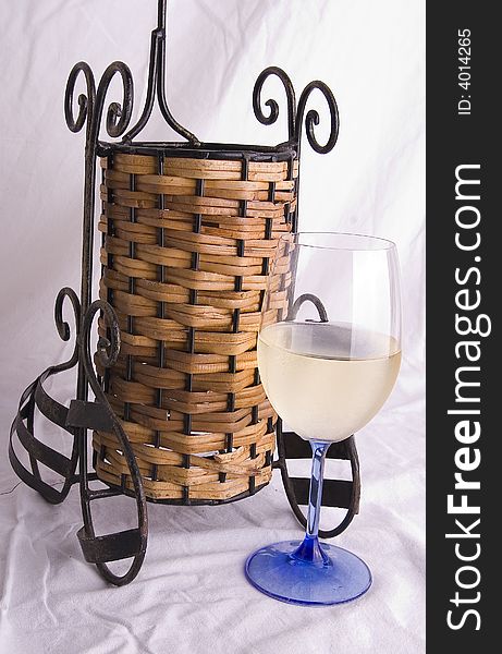 Wine glass and wine bottle holder with white background.