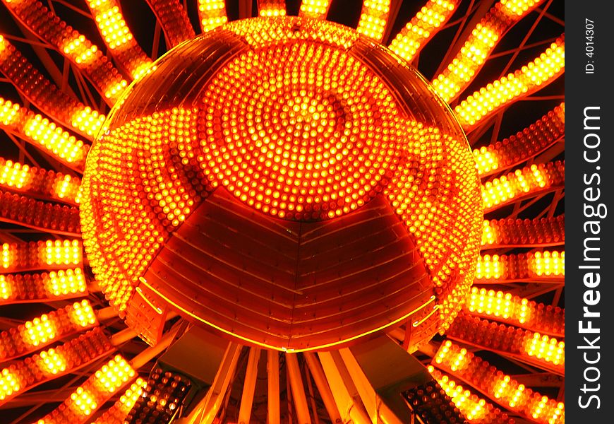 Lights in sunflower pattern at the hub of a ferris wheel. Lights in sunflower pattern at the hub of a ferris wheel.