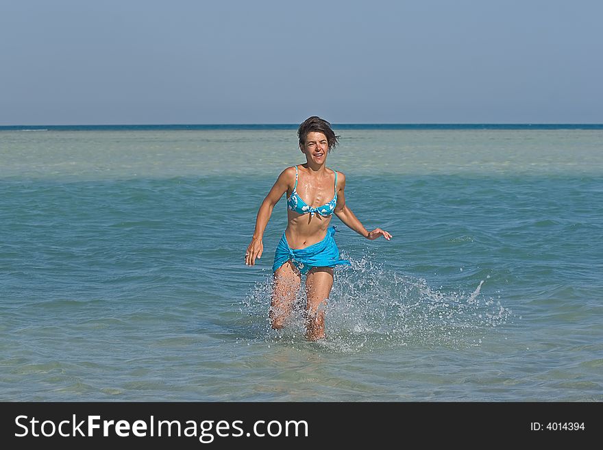 Woman running in water during summer. Woman running in water during summer