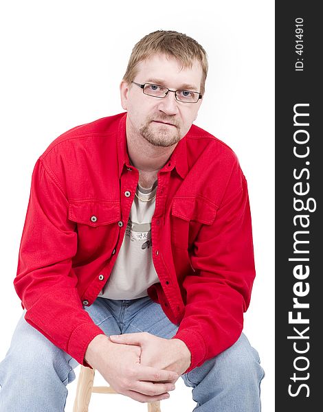 Man in red shirt sit on a little chair