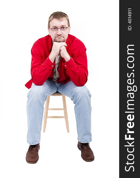 Man in red shirt sit on a little chair