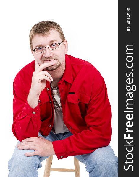 Man in red shirt sit on a little chair