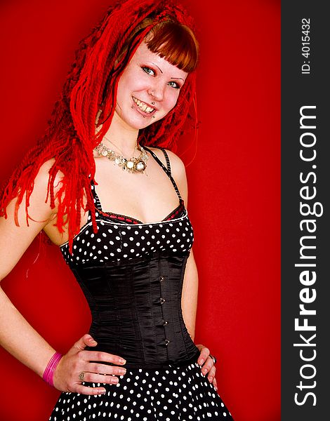 A beautiful gothic model with red hair. A beautiful gothic model with red hair