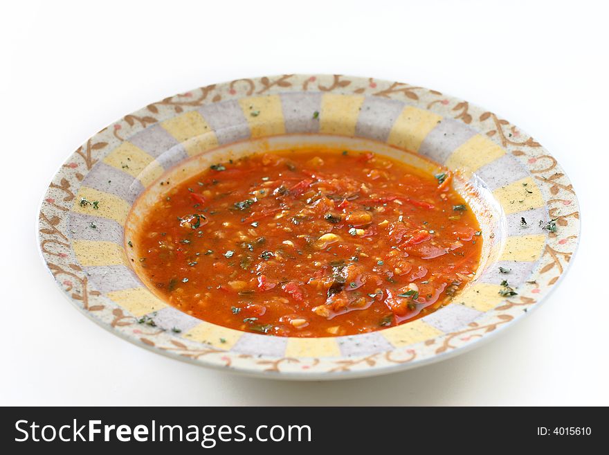 Chunky homemade tomato soup with chopped basil and garlic and a dash of olive oil