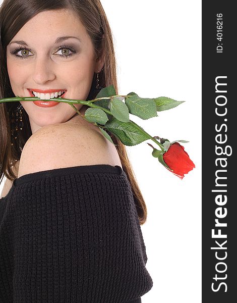 Beautiful brunette with a rose in her mouth isolated on white
