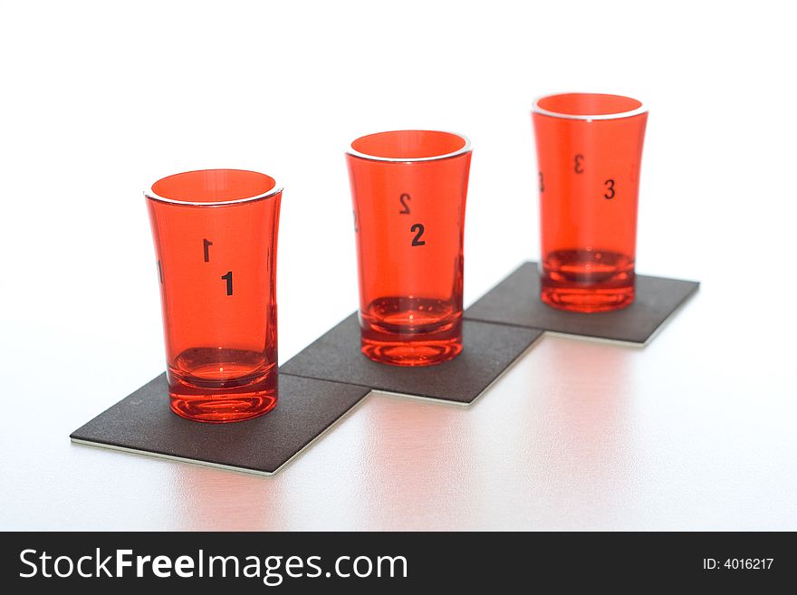 Three red glass numbered on black supports.