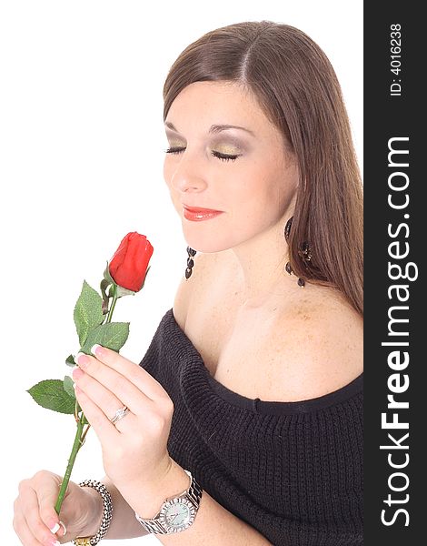 Brunette beauty smelling a rose isolated on white