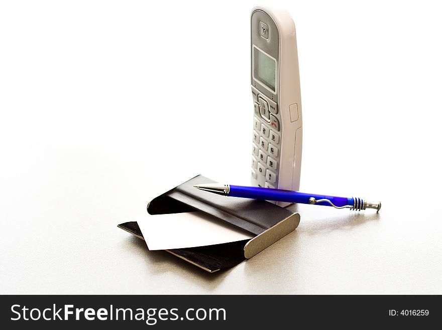 Pen laying on a case for cards and a telephone tub