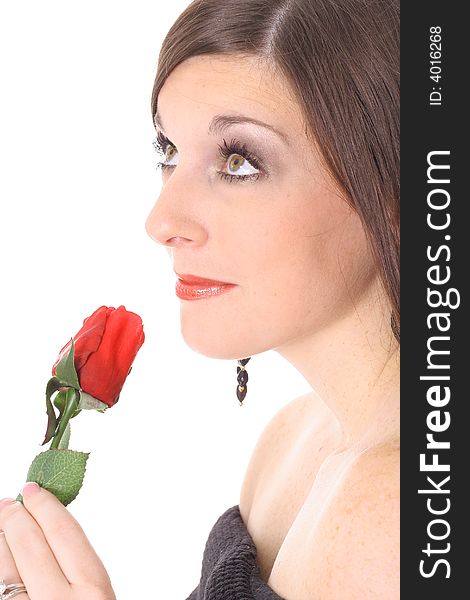 Brunette smelling a rose looking up