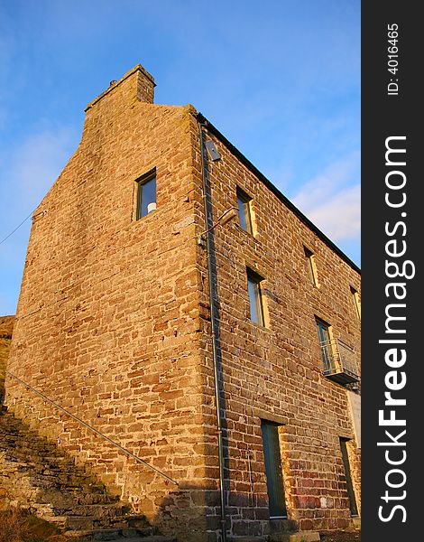 An old harbour side building converted and used as modern flats. An old harbour side building converted and used as modern flats.