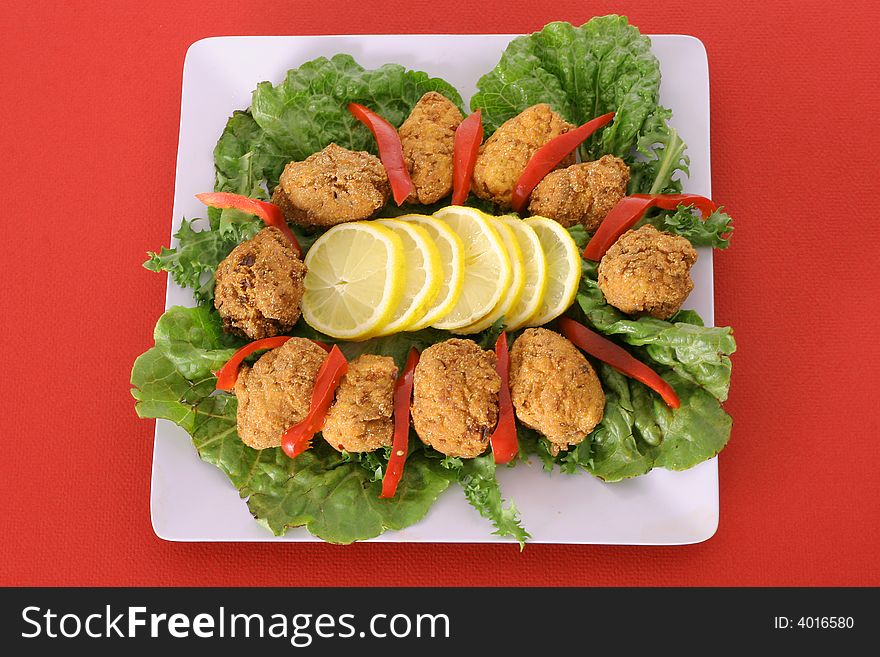 Fried appetizer platter isolated on red