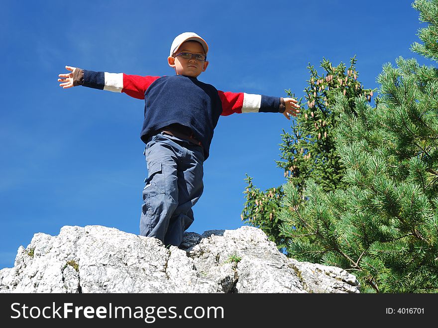 Boy on top of the rock. Boy on top of the rock