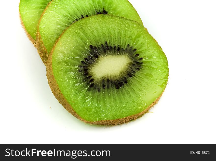 Slices of green kiwi isolated on white