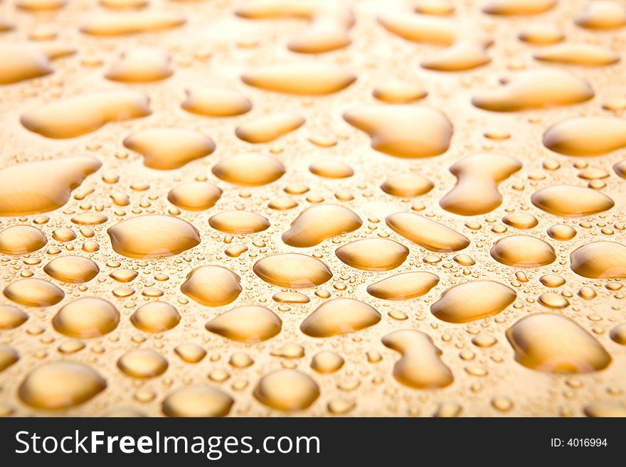 Water drops background, a golden abstract closeup with limited dof. Water drops background, a golden abstract closeup with limited dof