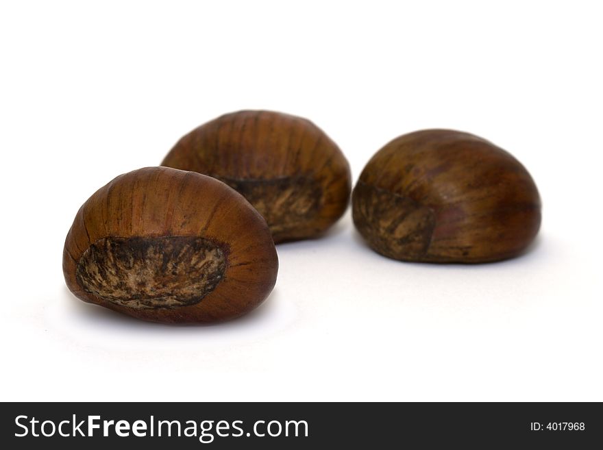 Close-up of three chestnuts isolated