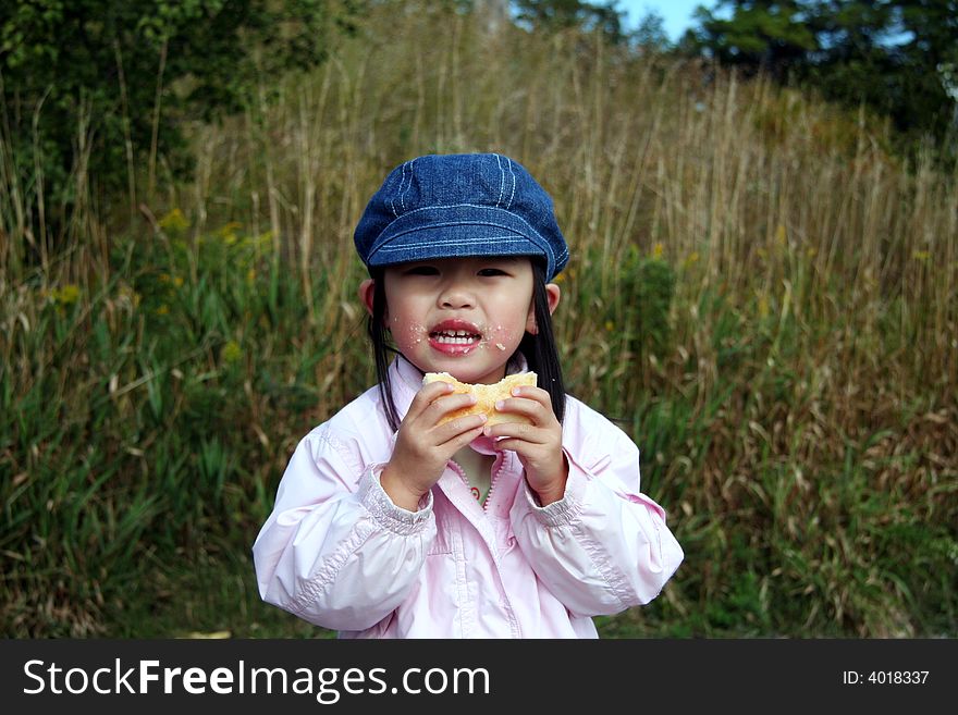 Toddler having an outdoor snack. Toddler having an outdoor snack