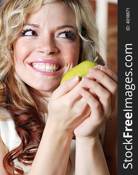 Beautiful woman is holding a fruit in her hands. Beautiful woman is holding a fruit in her hands