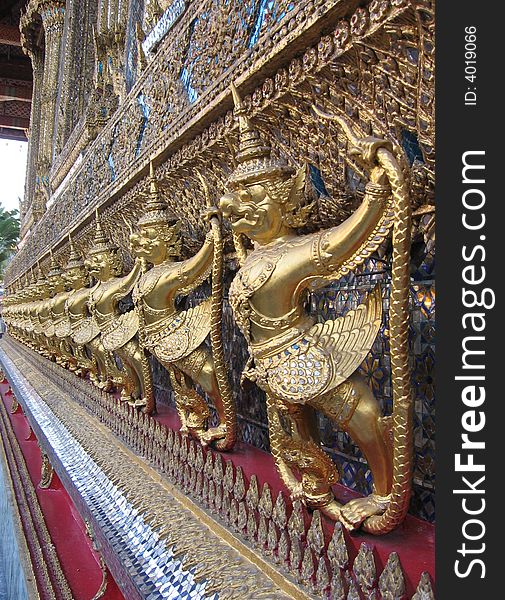 A row of statues on the wall of a temple in Bangkok. A row of statues on the wall of a temple in Bangkok