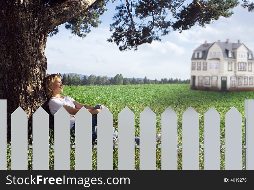 Young beauty woman sit under alone tree in field