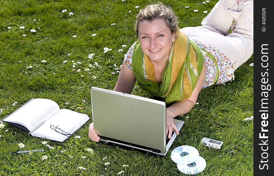 Young woman with laptop on grass. Young woman with laptop on grass