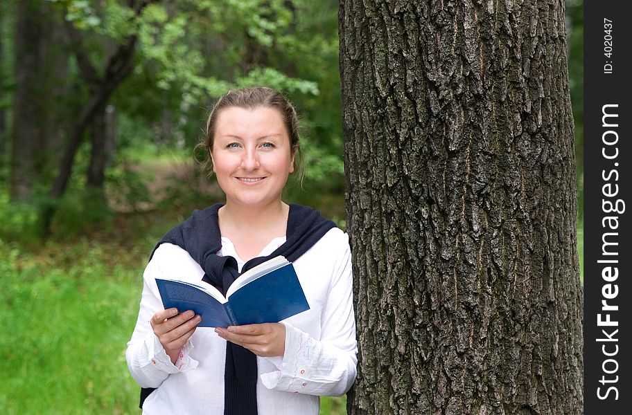 Young woman with book in the park. Young woman with book in the park