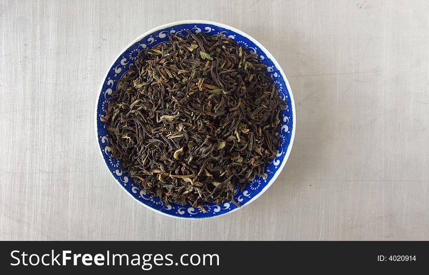 Porcelain saucers with green darjeeling tea. Porcelain saucers with green darjeeling tea