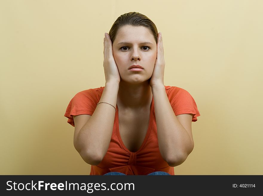 Woman closes ears with hands. Woman closes ears with hands