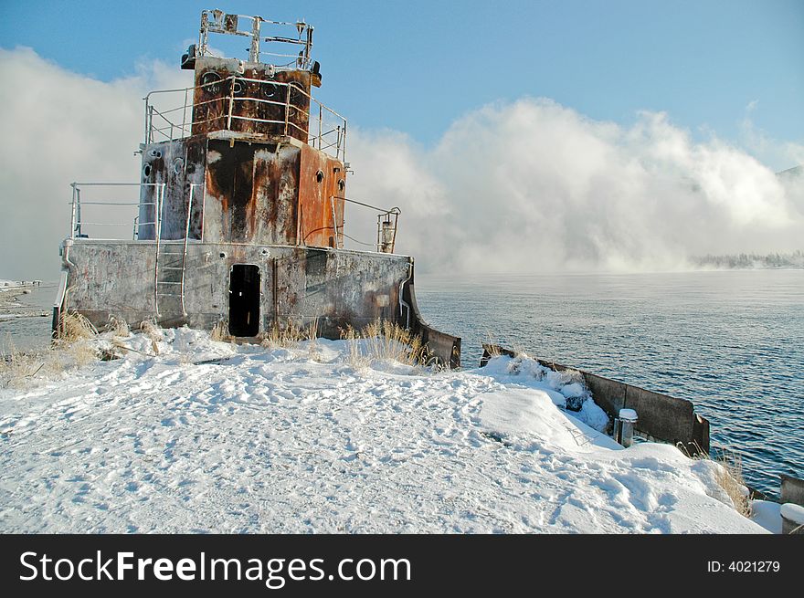 Old a river vessel. A fog. The river Yenisei in the winter. Old a river vessel. A fog. The river Yenisei in the winter.