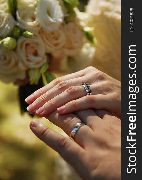 Wedding rings on fingers of young pair