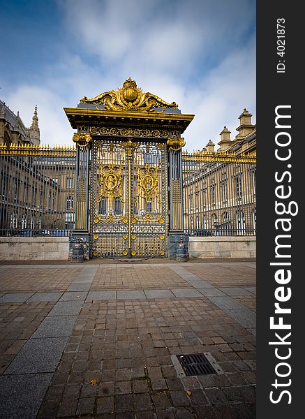 Wide angle view of an imposing golden gateway.