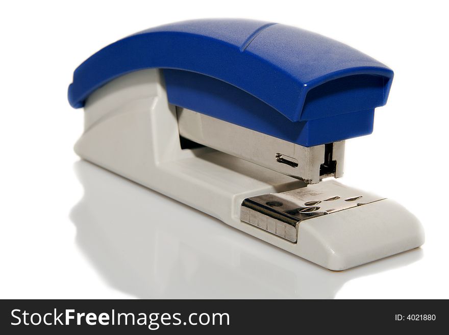 A blue plastic stapler a light background