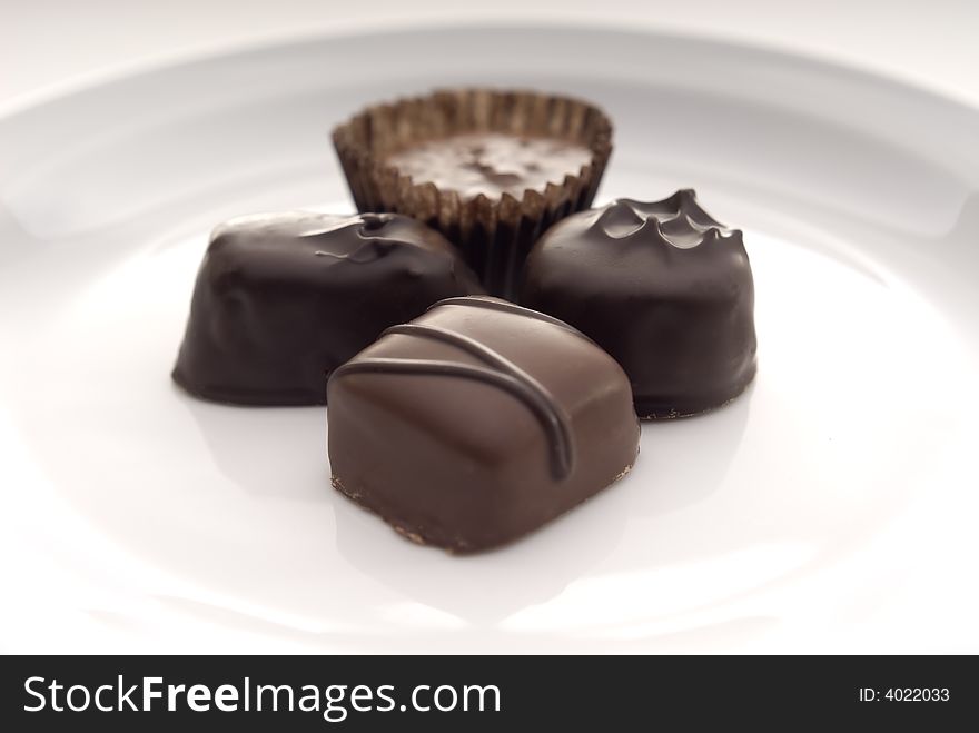 Close Up Of Chocolates On A White Plate