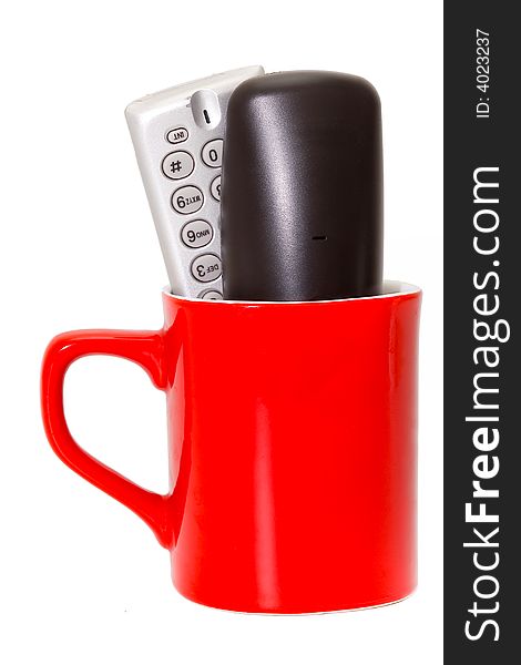 Two cordless phones in a mug