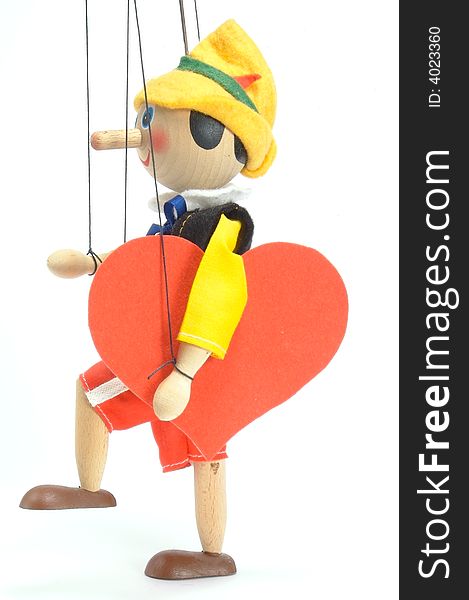 Wooden doll - marionette. Joyfully it steps with the enormous red
heart. Side view. Valentine's Day. Wooden doll - marionette. Joyfully it steps with the enormous red
heart. Side view. Valentine's Day.