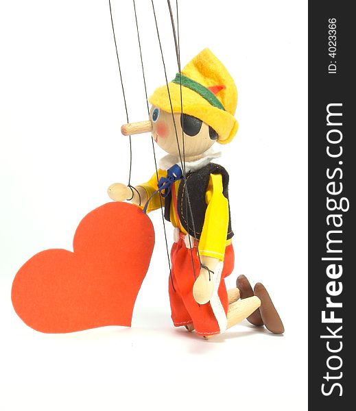 Wooden doll - marionette. It stands on the elbows. It rests on the
enormous red heart. Valentine's Day. Wooden doll - marionette. It stands on the elbows. It rests on the
enormous red heart. Valentine's Day.