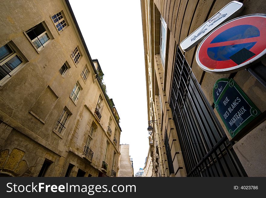 Wide angle view of Paris architecture with a no parking sign. Wide angle view of Paris architecture with a no parking sign.