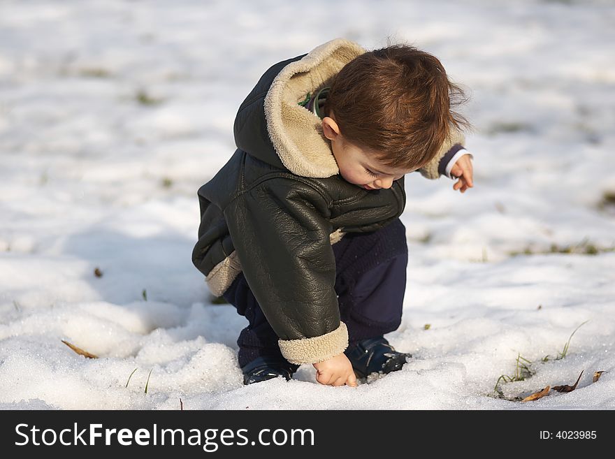 First snow. Cute toddler in snow.