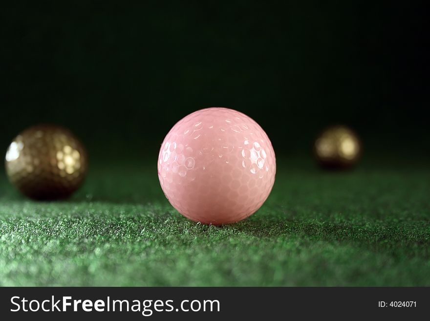 Pink golfballs with golden friends waiting for continous play