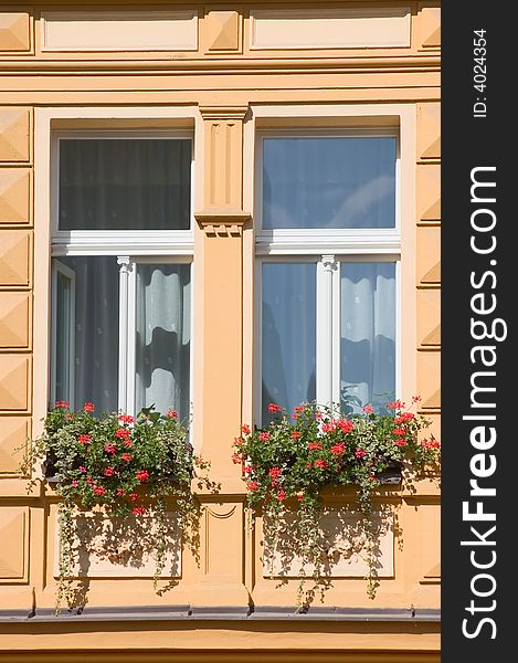 Windows of Prague building with red flowers. Windows of Prague building with red flowers.