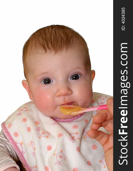 4 months old baby girl eating pap or puree with vegetables and fruit, isolated on white. Fed by mother. 4 months old baby girl eating pap or puree with vegetables and fruit, isolated on white. Fed by mother.