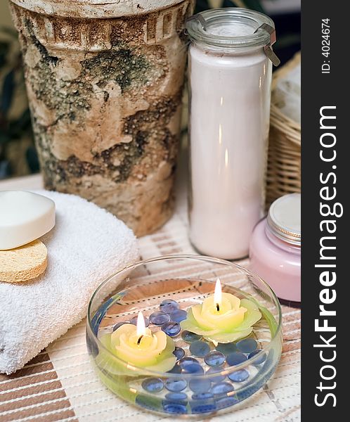 A spa composition consisting of bottle, towel, sea shell and candles submerged in a glass bowl with water. MORE SPA COMPOSITIONS Â». A spa composition consisting of bottle, towel, sea shell and candles submerged in a glass bowl with water. MORE SPA COMPOSITIONS Â»