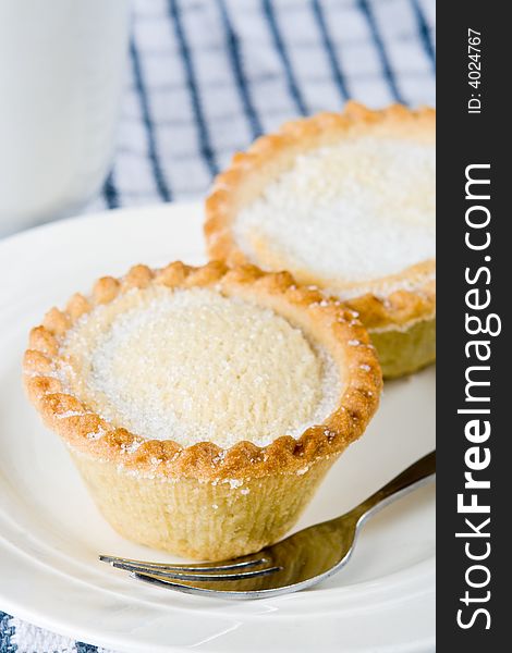 Two mince pies with a fork on a plate. Two mince pies with a fork on a plate