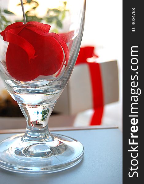 Gift box with red ribbon and fabric heart inside the glass. Gift box with red ribbon and fabric heart inside the glass