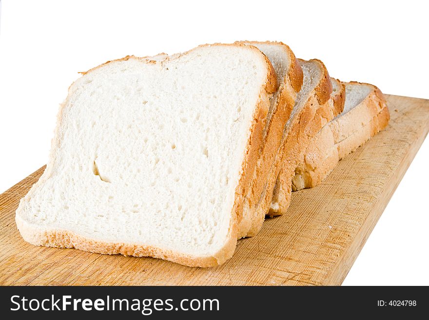 Five slices of white bread on a wooden cutting board (isolated)